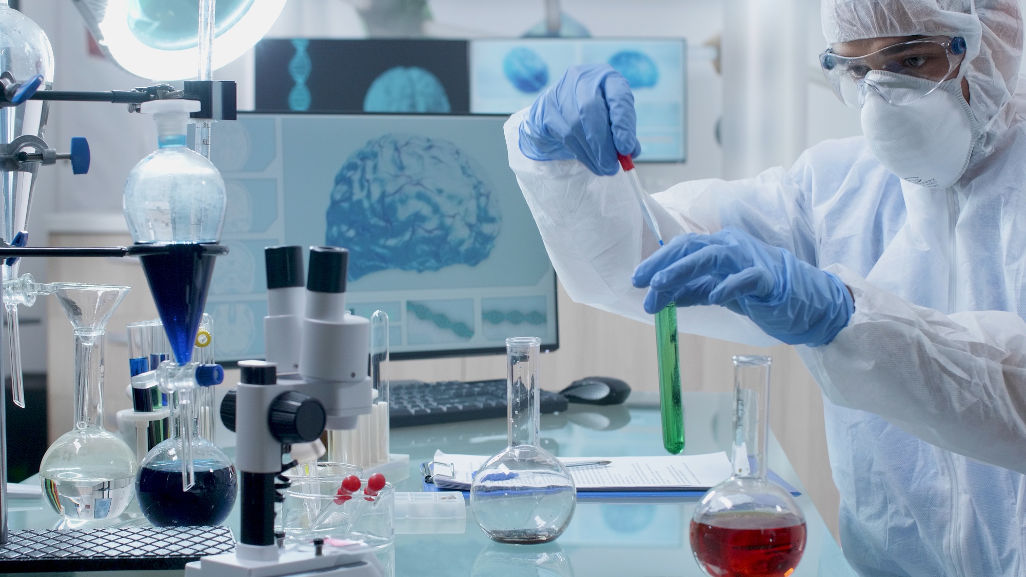 Researcher chemist doctor with ppe equipment doing chemical experiment